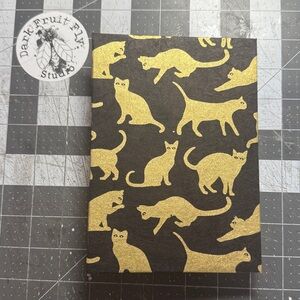 Pre-order today! Gold cats on black. Hand Sewn Artist Journal Made in Alaska.